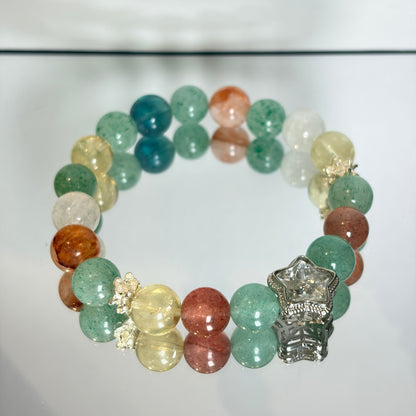 Handmade crystal bracelet with clear quartz bangle, strawberry quartz, lemon citrine, green aventurine and blue fluorite beads, featuring a clear quartz star charm